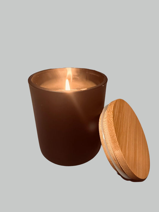 lotion candle in a brown candle jar and beige top