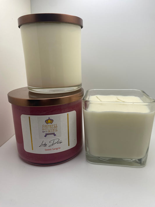 one cylindrical-shaped candle jar with white candle wax, one cylindrical-shaped candle jar with wine-colored candle wax and one cube-shaped candle jar with white candle wax