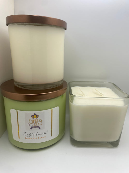 one cylindrical candle jar with white candle wax, one cylindrical candle jar with light green candle wax and one cube-shaped candle jar with white candle wax