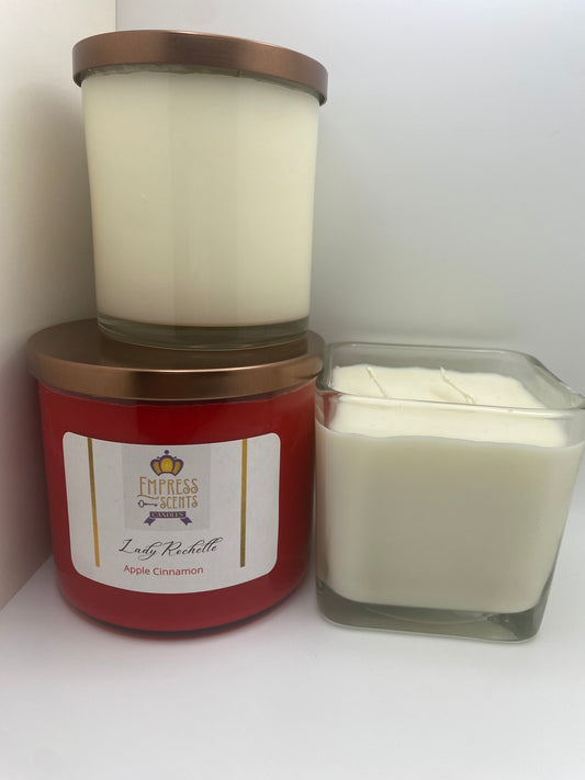 one cylindrical candle jar with white candle wax, one cylindrical candle jar with red candle wax and one cube-shaped candle jar with white candle wax