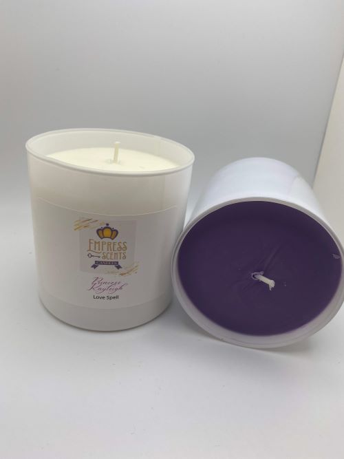 one small cylindrical candle jar with white candle wax and one small cylindrical candle jar with purple candle wax